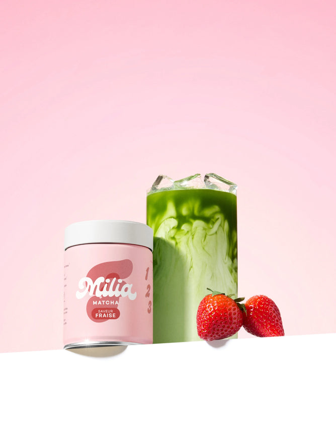Canette matcha cérémonie Milia Matcha saveur fraise avec matcha latte glacé et deux fraises sur fond rose